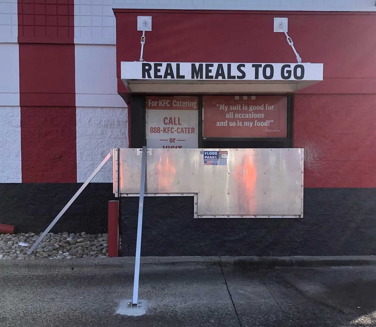 A red and white building with a sign that says real meals to go