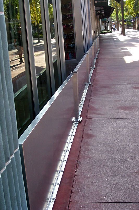 A sidewalk with a metal barrier on the side of it