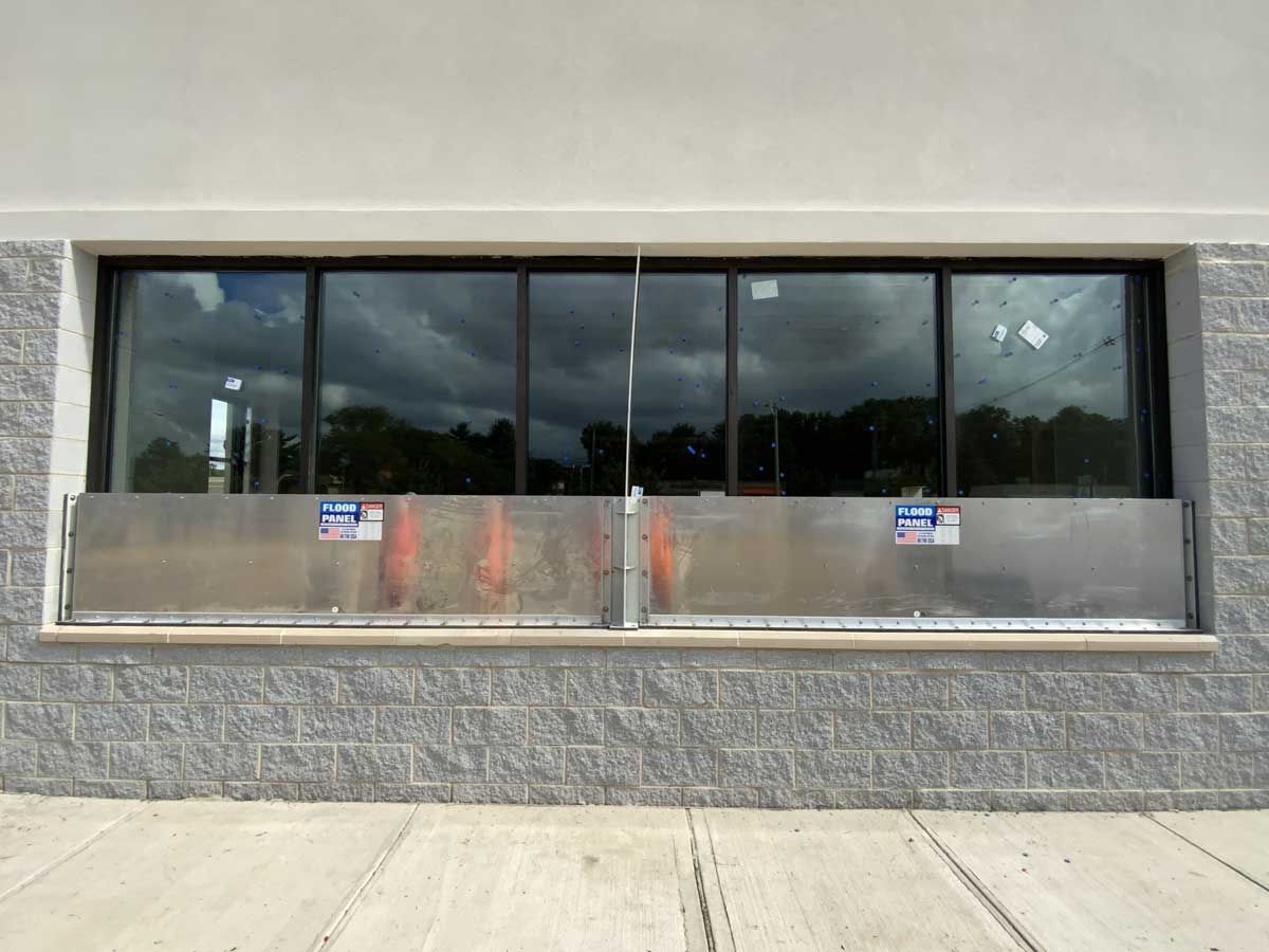 A large window with a stainless steel barrier on the side of it.