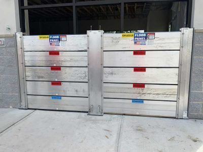A pair of flood panels are sitting on the sidewalk
