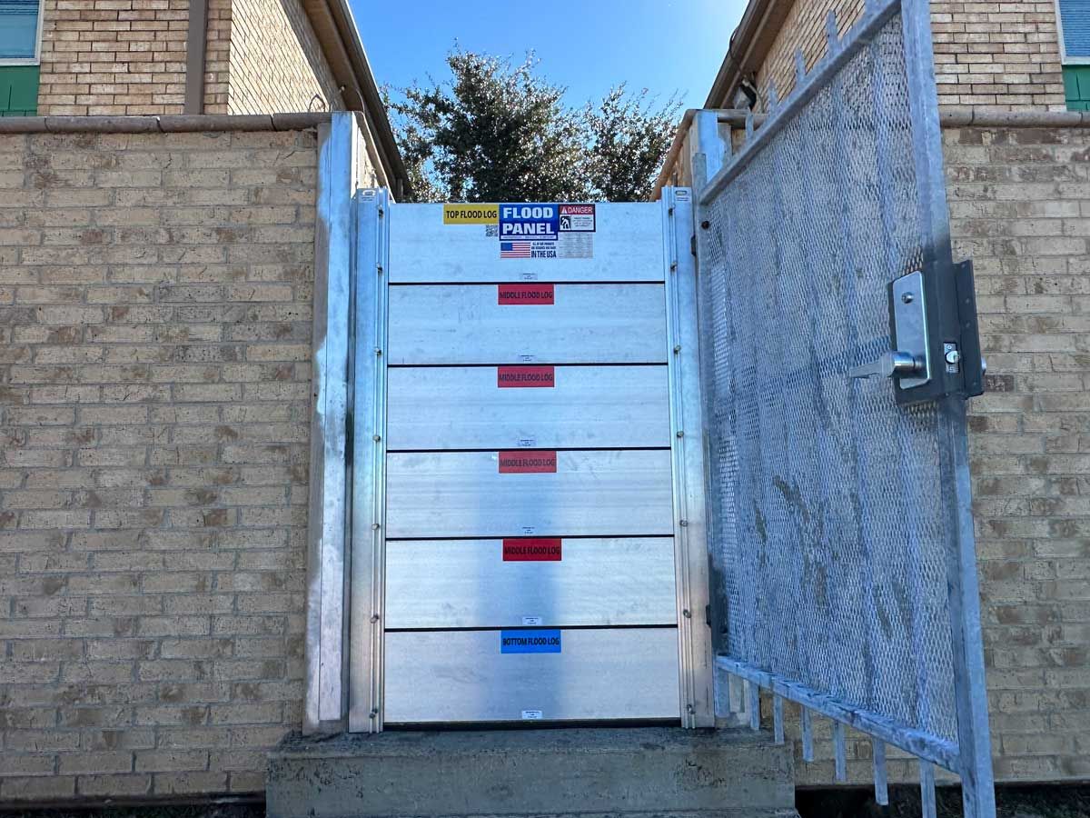 A brick building with a metal gate leading to it.