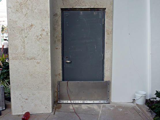A door with a stainless steel barrier around it