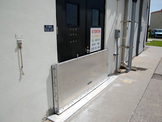 A flood barrier is installed on the side of a building.