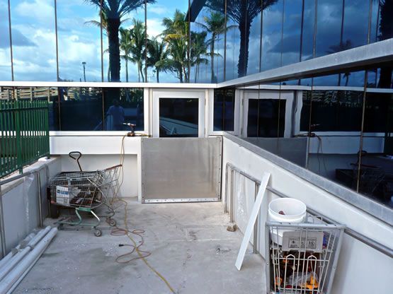 A shopping cart is sitting in front of a building under construction