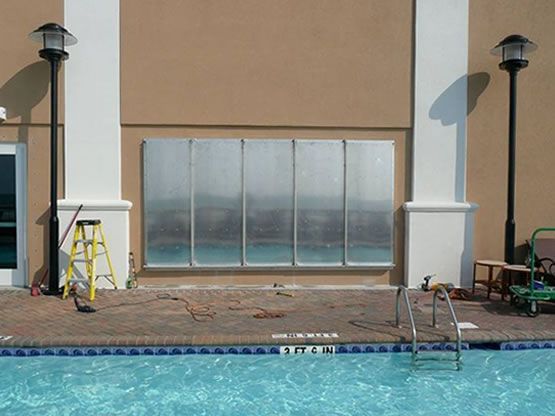 A ladder sits on the edge of a swimming pool