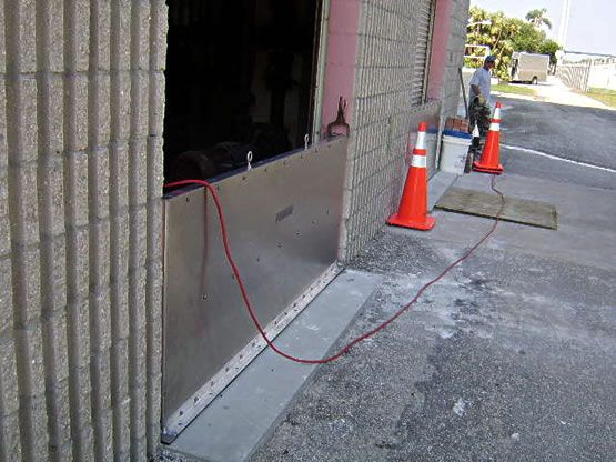 A man is standing in front of a building with a red cord attached to it.
