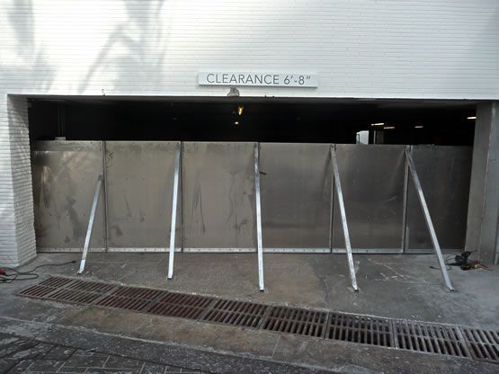 A clearance sign is above a stainless steel gate
