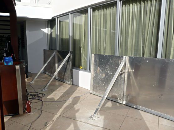 A balcony with a sliding glass door and a metal barrier