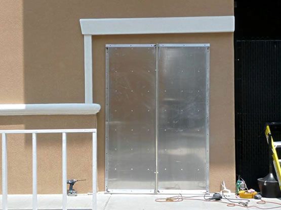 A sliding glass door is being installed on the side of a building