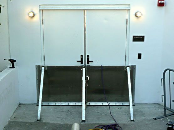 A white door with a metal barrier behind it
