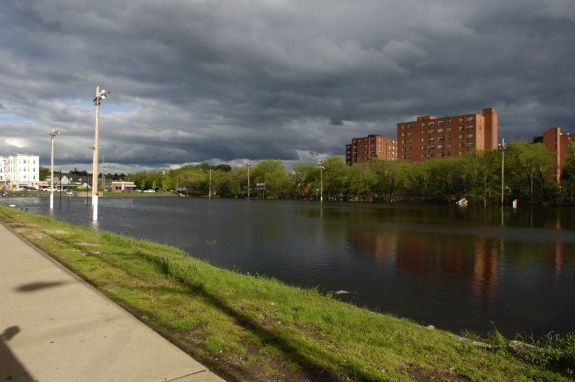 A large body of water with buildings in the background