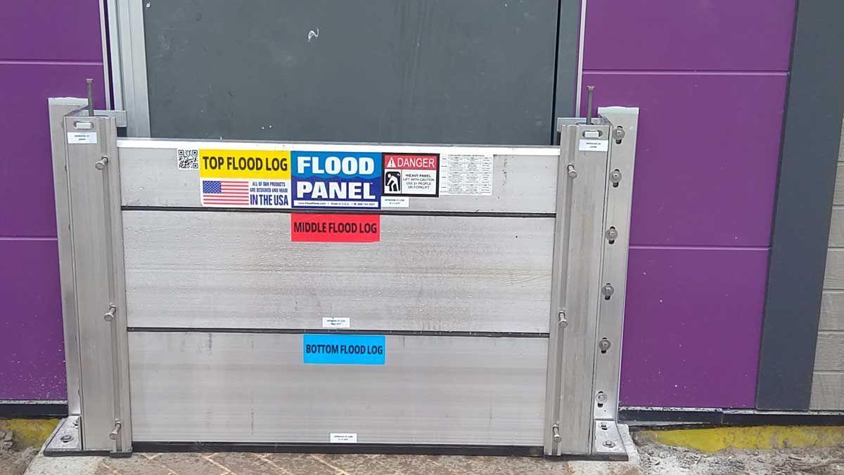 A flood panel is sitting in front of a purple door.