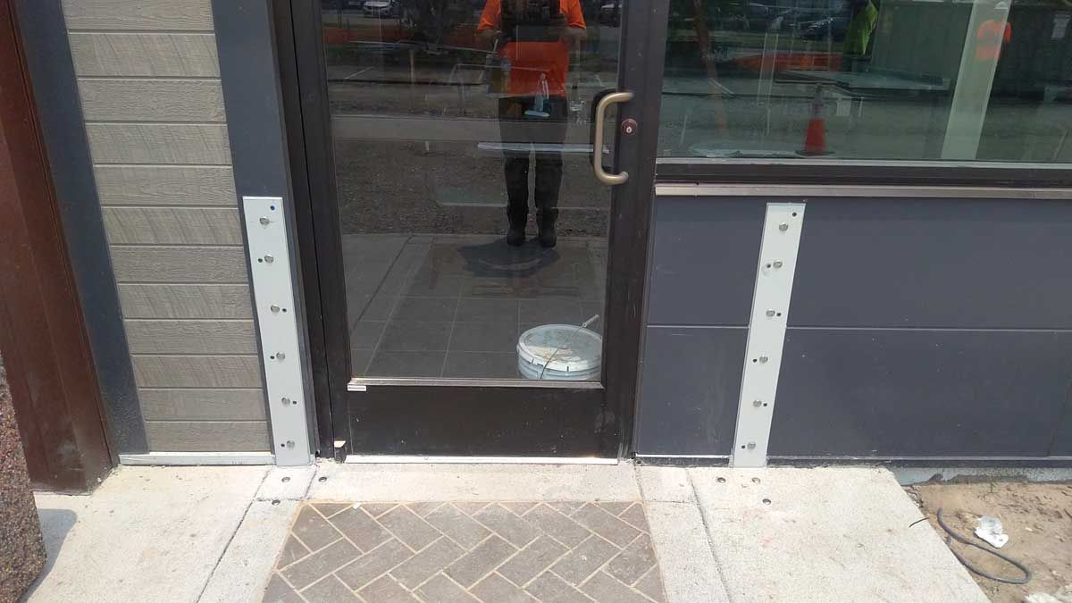 A person is standing in the doorway of a building.