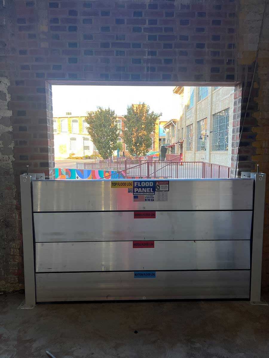 A flood barrier is sitting in front of a window in a building.