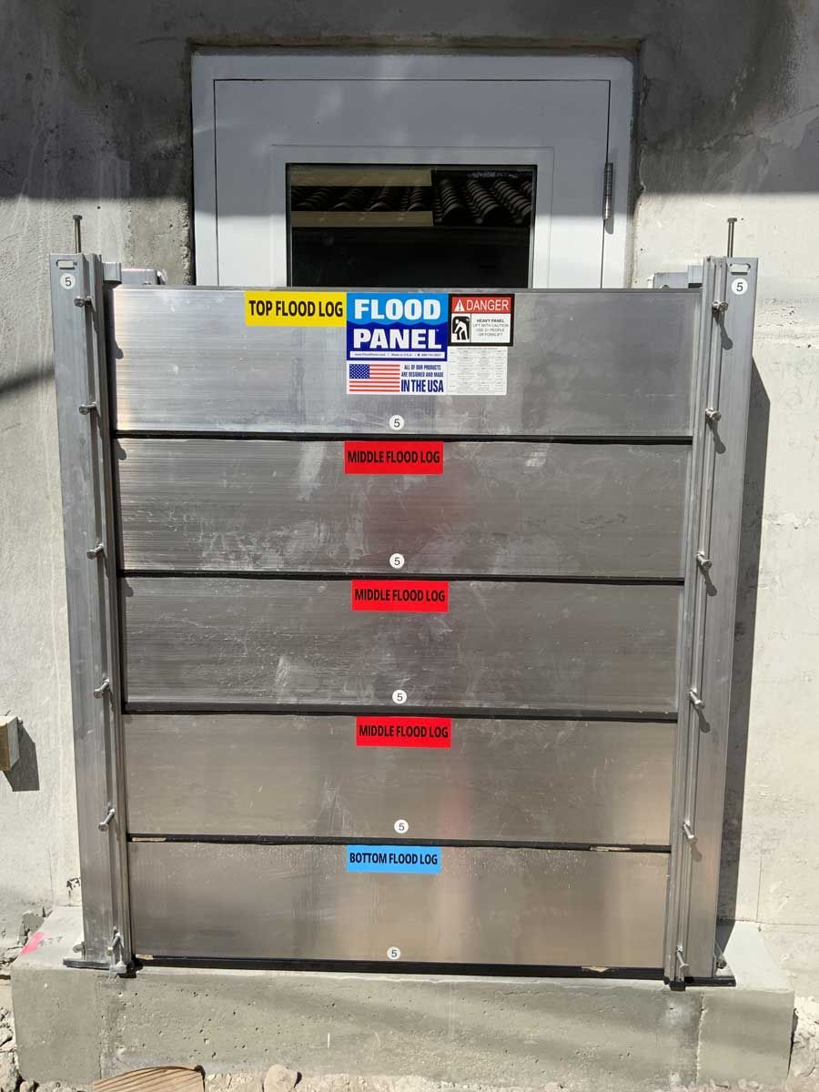 A stainless steel flood panel is in front of a door