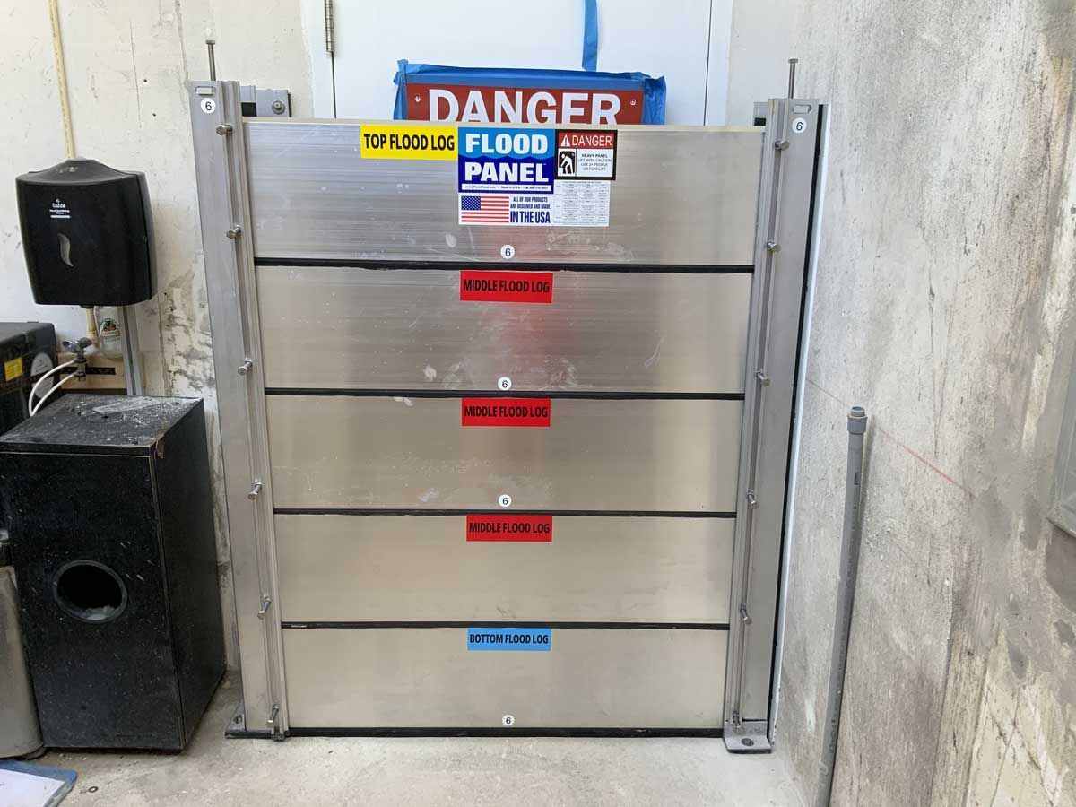 A stainless steel wall with a danger sign on it
