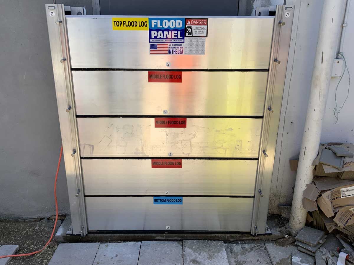 A flood panel is sitting on the side of a building.