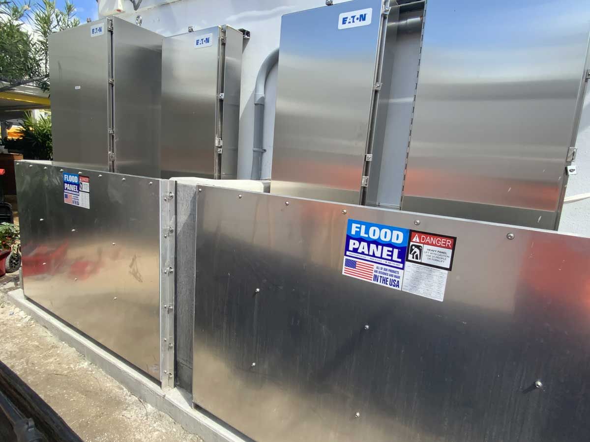 A stainless steel flood panel is sitting on the side of a building.