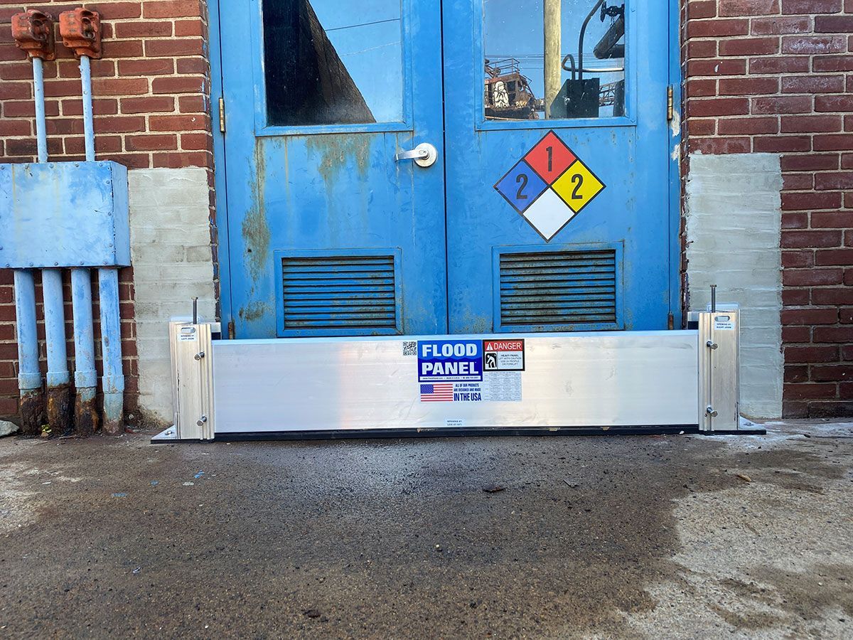 A blue door with a flood panel in front of it