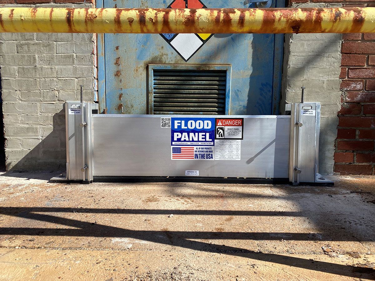 A flood panel is attached to the side of a building