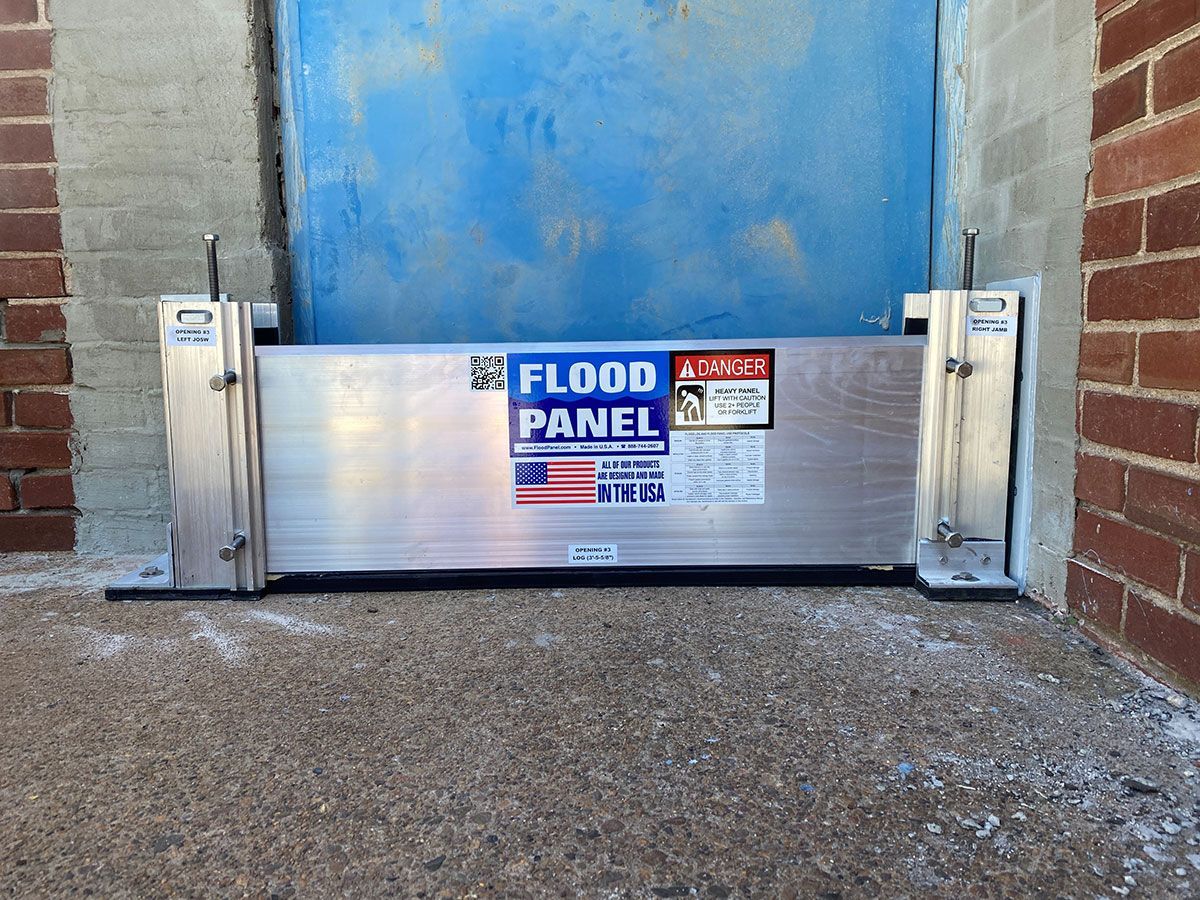 A flood panel is sitting in front of a blue door.