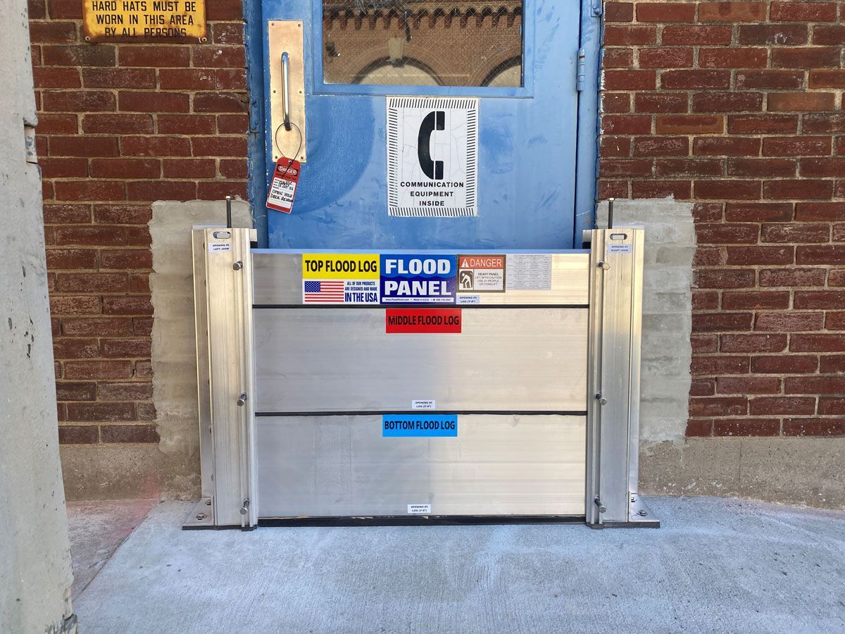A blue door with a flood panel in front of it