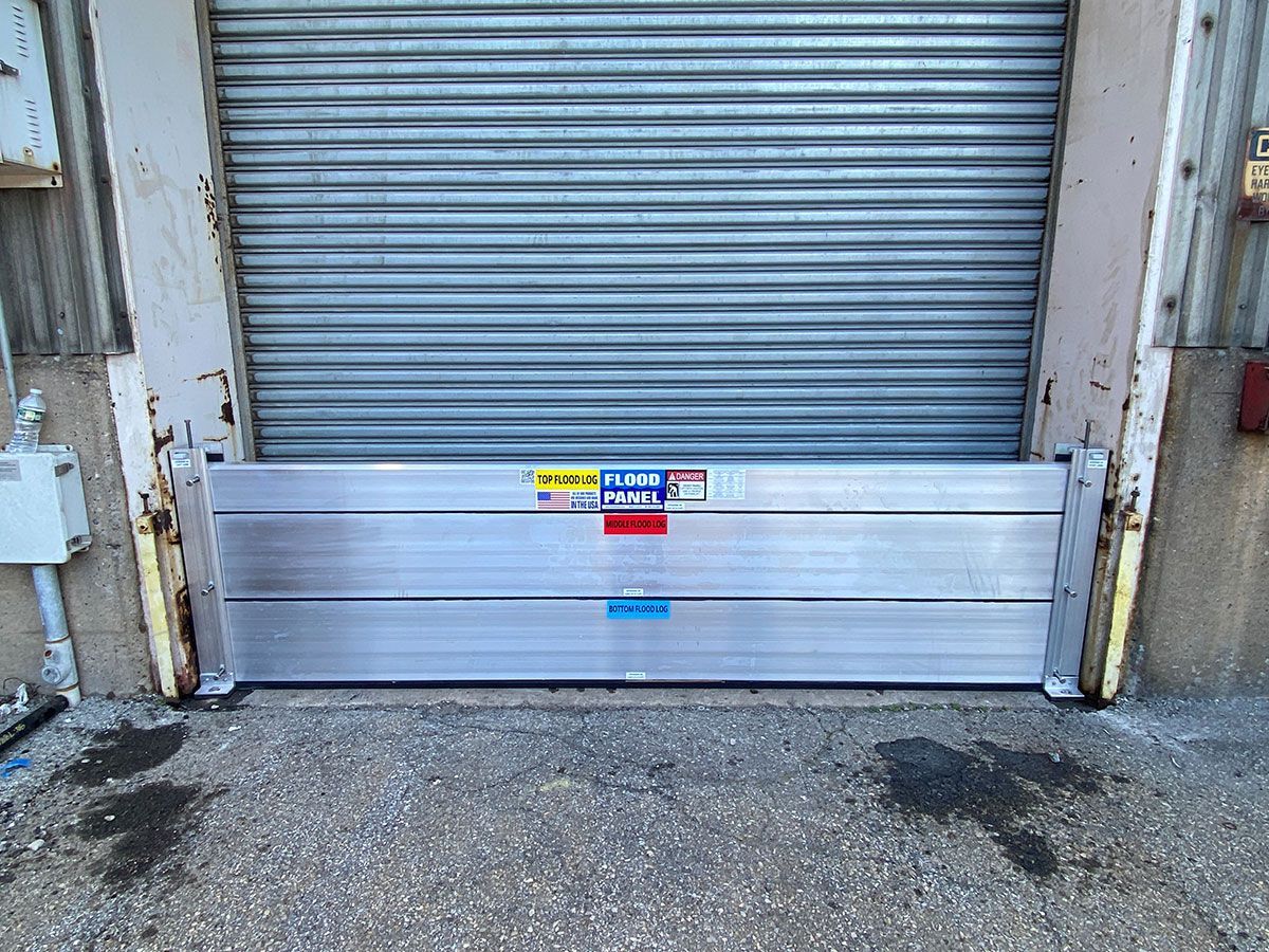 A metal door with a flood barrier attached to it.