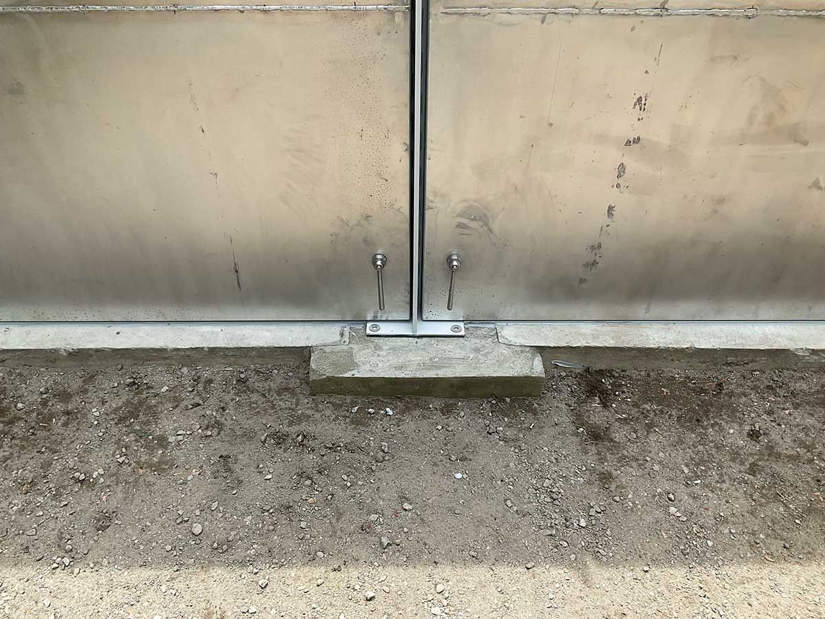A stainless steel door is sitting on top of a concrete floor.