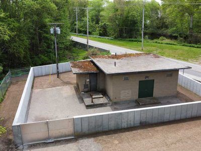 An aerial view of a small building with a fence around it.