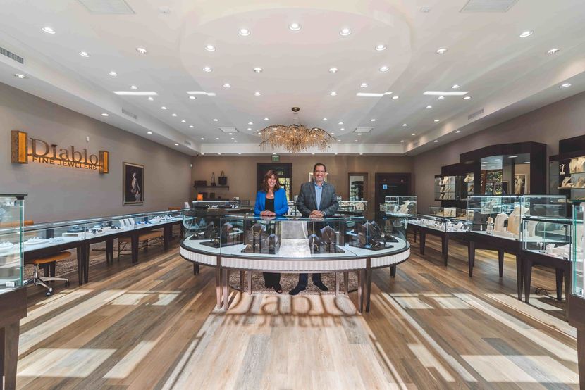 A man and a woman are standing in a jewelry store.