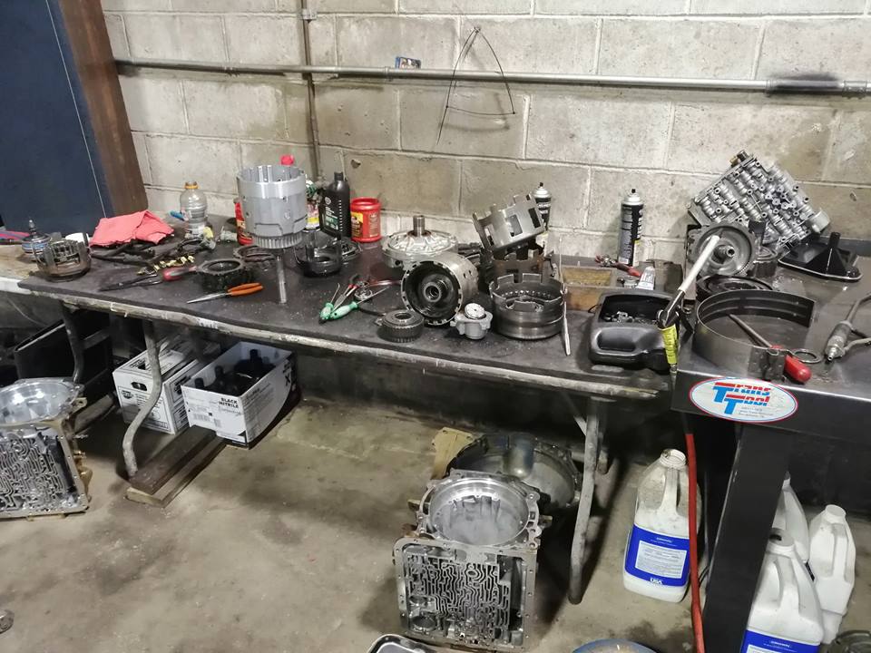A table with a lot of tools on it in a garage.