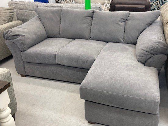 A grey sectional couch with a chaise lounge in a living room.
