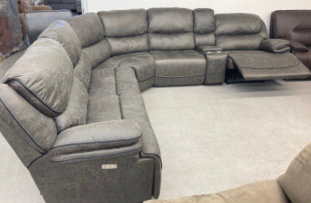 A large sectional couch is sitting in a living room.