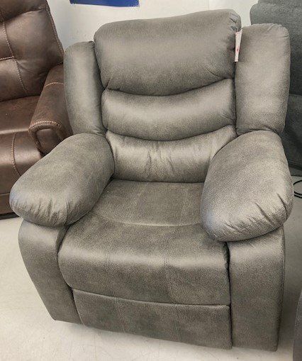 A grey leather recliner is sitting in a room next to a brown leather recliner.