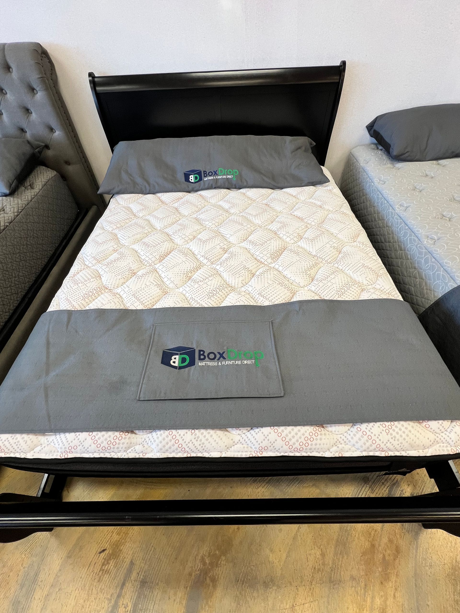 A bed with a mattress and pillows on it in a room.