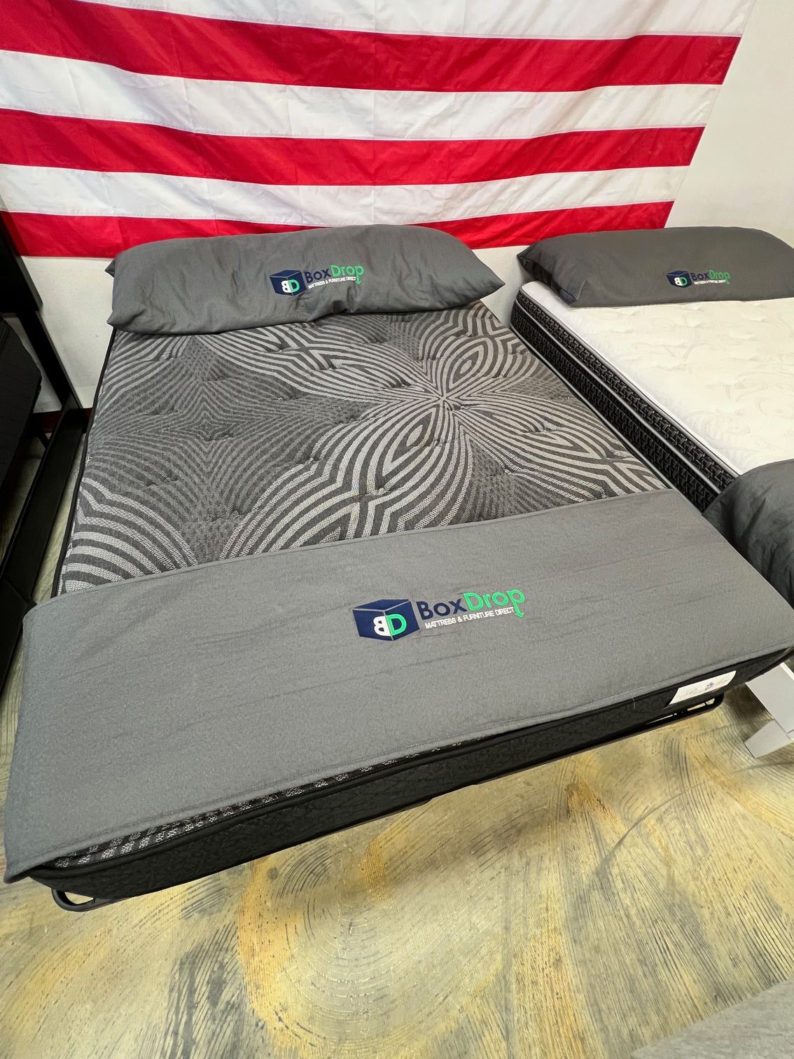 A mattress is sitting on top of a bed next to a flag.