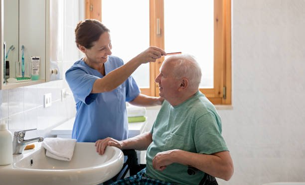 Volunteer brushing pensioner's hair