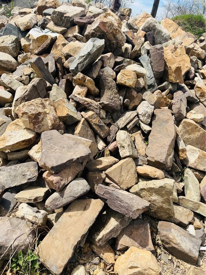 Pile of various sized tan, brown, and gray rocks.