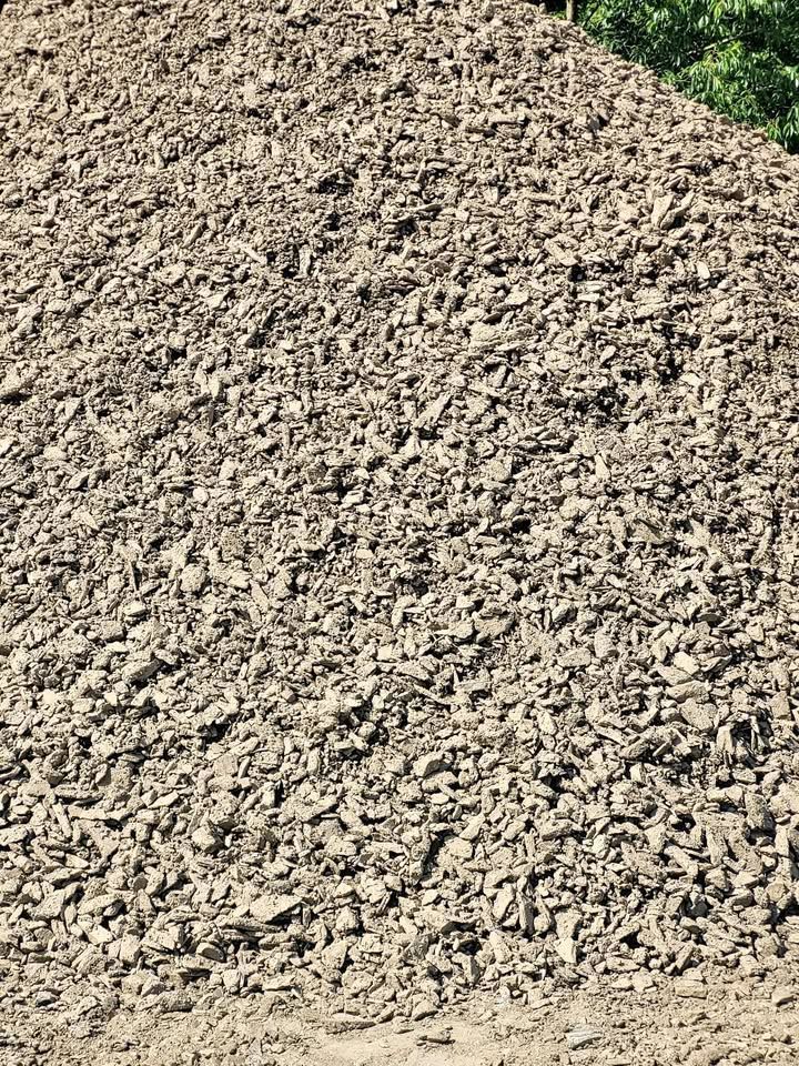 Pile of gray-brown, chipped stone or gravel, possibly for landscaping or construction.