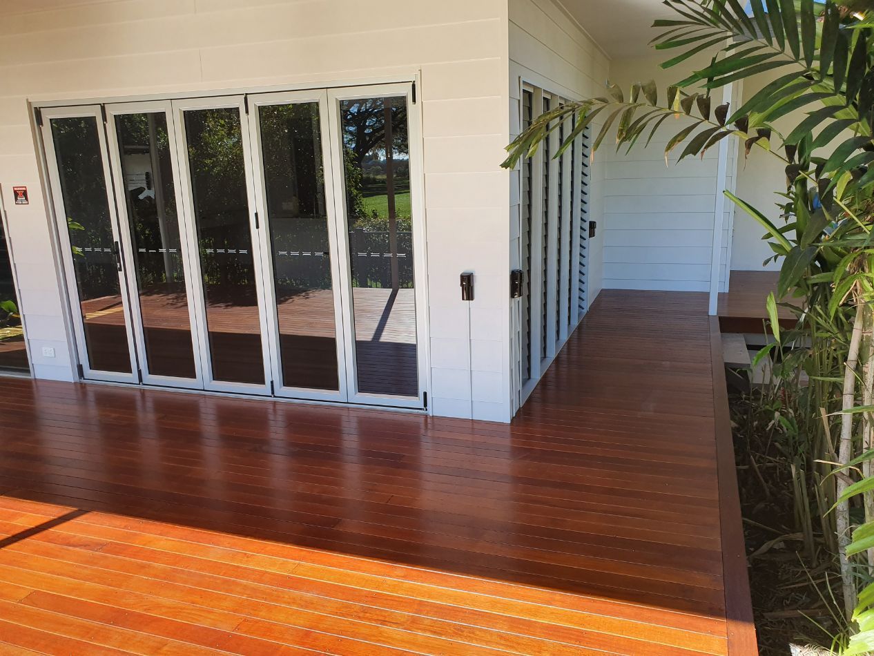 Serene Deck Featuring Glass Doors and Timber Flooring — Construction Company in Townsville, QLD