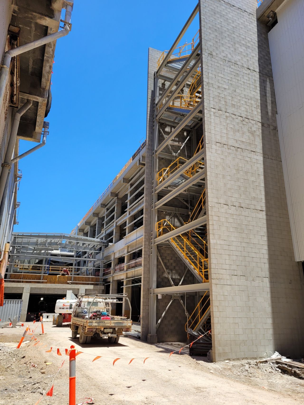 Construction site: multi-story building under construction, with exposed metal framework and stairs  — Construction Company in Townsville, QLD