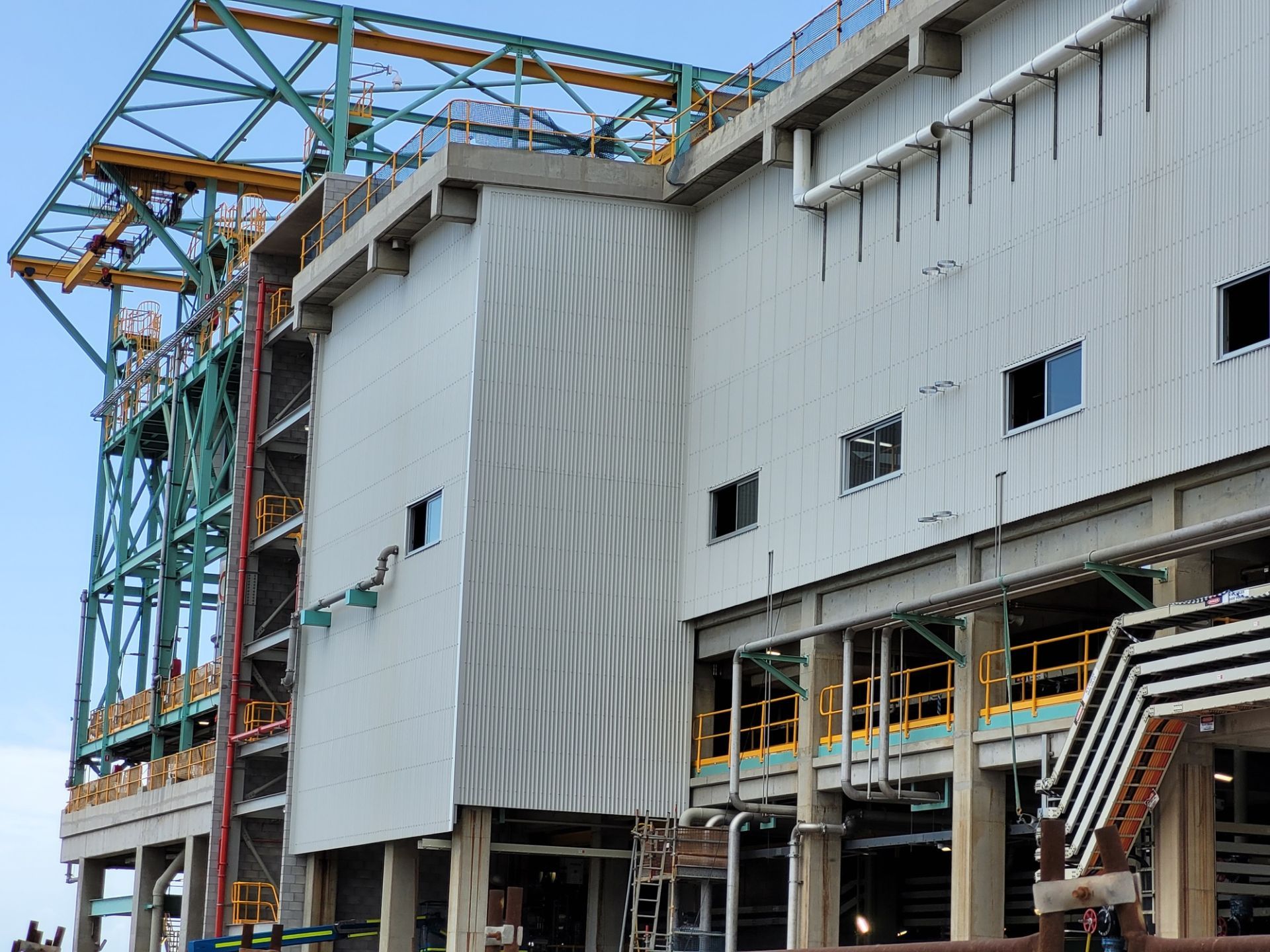 Industrial building exterior with metal siding, structural framework, and small windows — Construction Company in Townsville, QLD