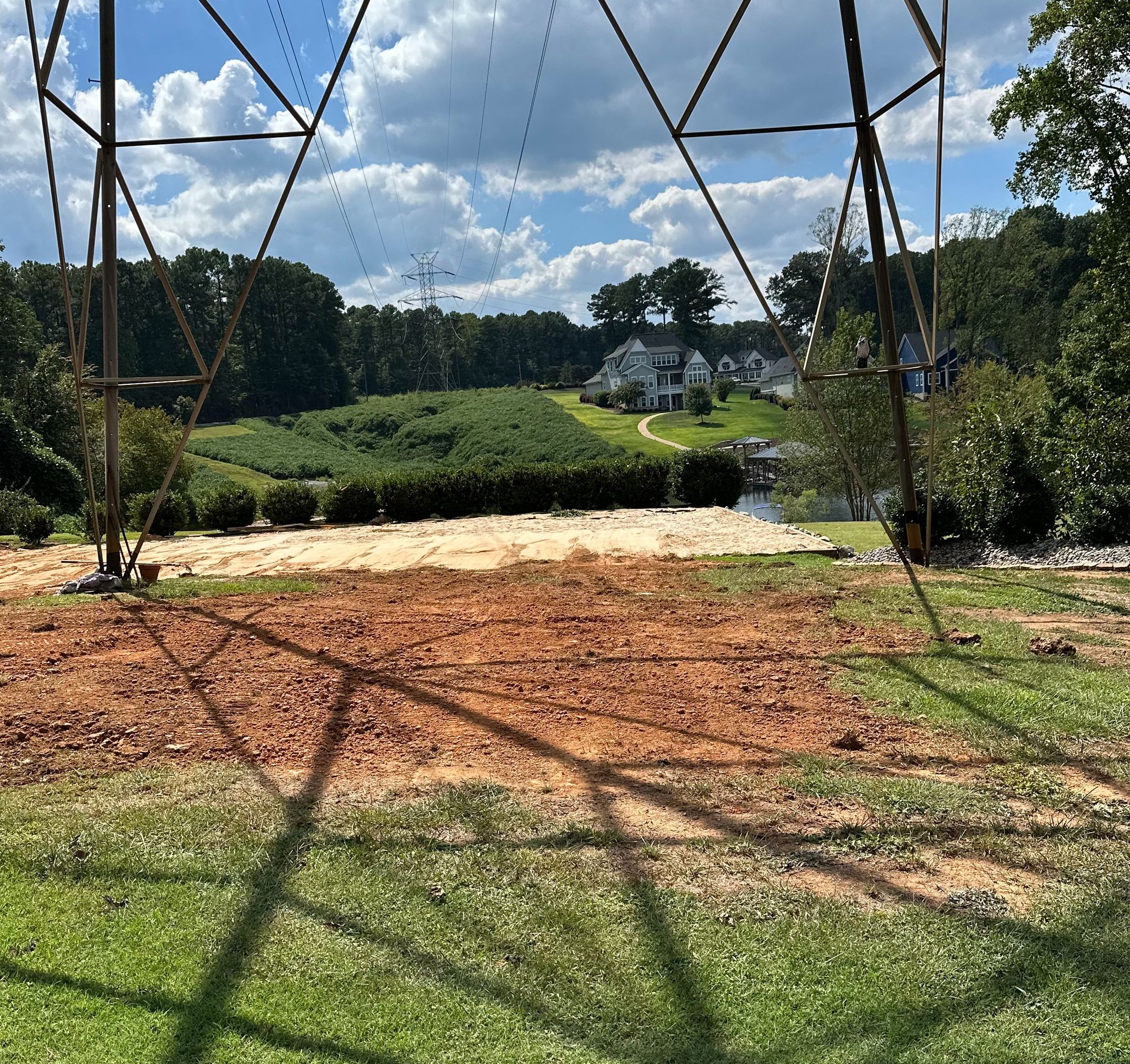 A shadow of a power line is cast on a grassy field