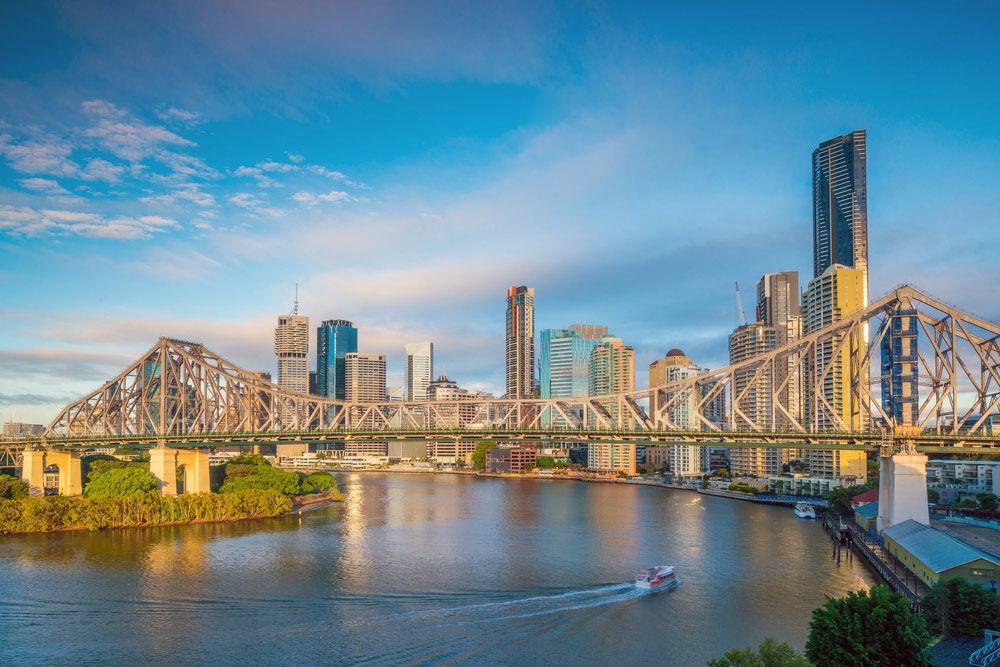 An Aerial View of A Bridge Over a River with A City Skyline in The Background — Fireline 2000 Fire Equipment Pty Ltd in Brisbane, QLD