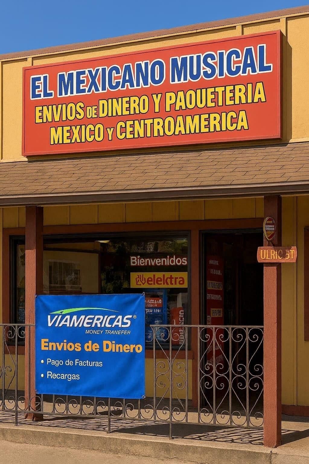 Tan commercial building with a blue sign that reads 
