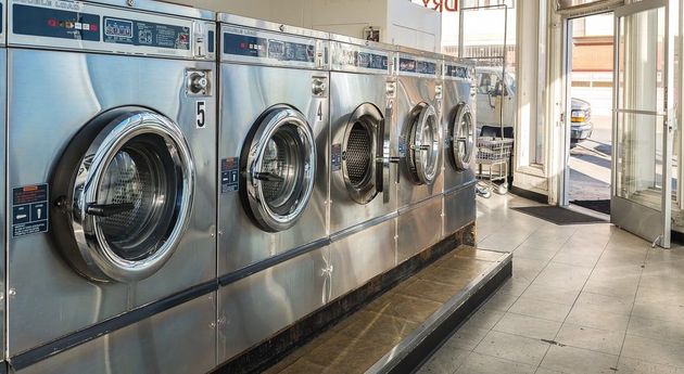 A row of washing machines in a laundromat.