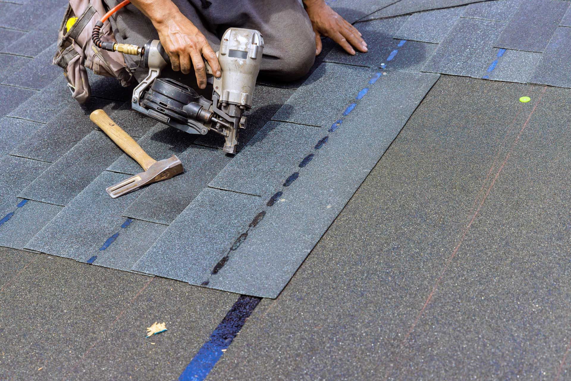 Person install asphalt shingles roof