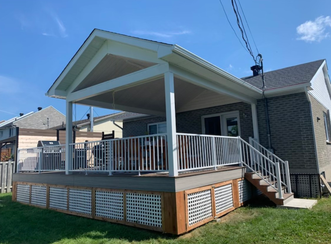 L'arrière d'une maison avec un porche et des escaliers.