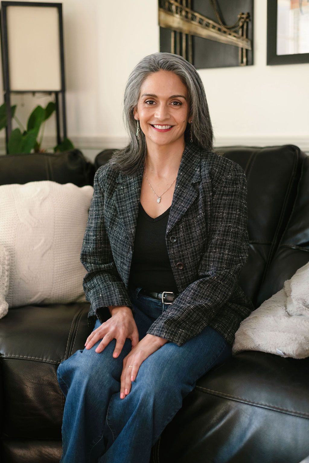 Judith Watkins is sitting on a black leather couch