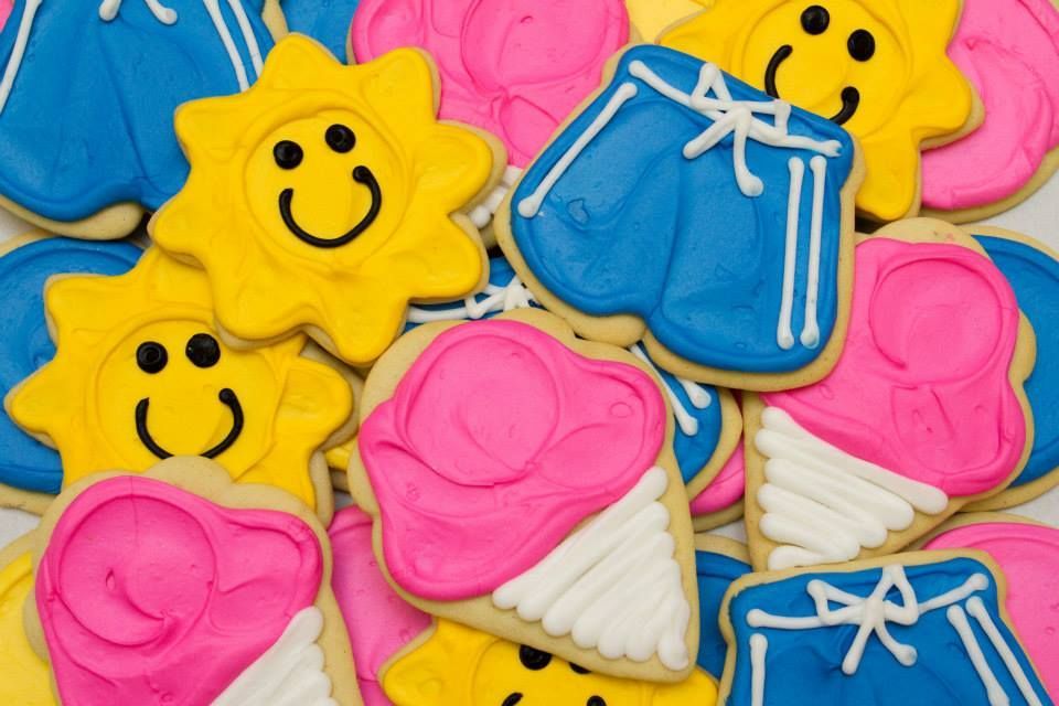 A pile of colorful cookies with smiley faces on them